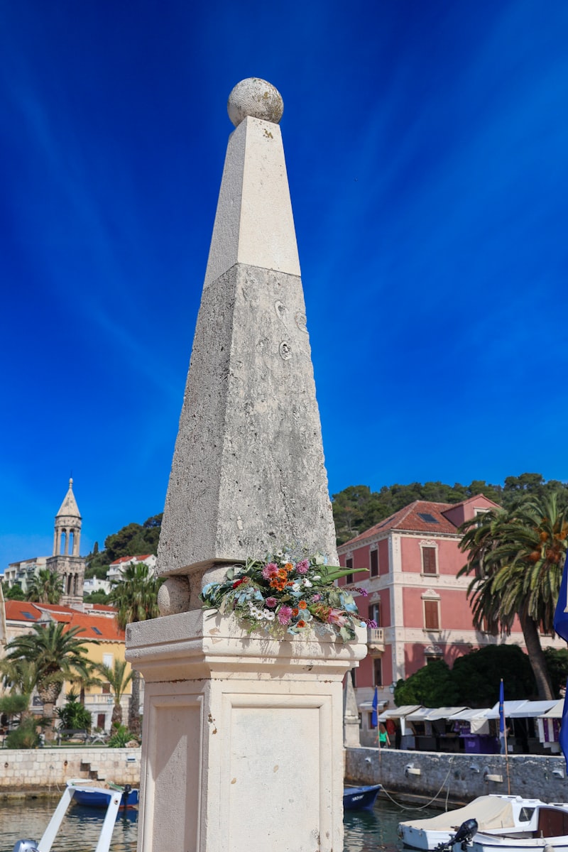 a monument with a clock tower in the background